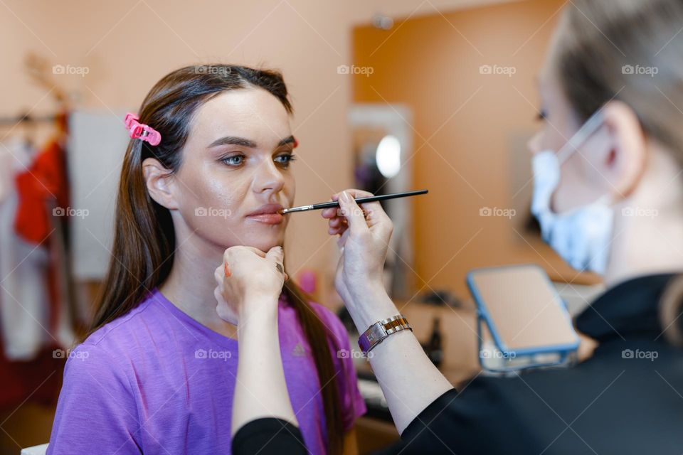 Makeup artist at work.  Applying makeup to a woman.  Professional cosmetics