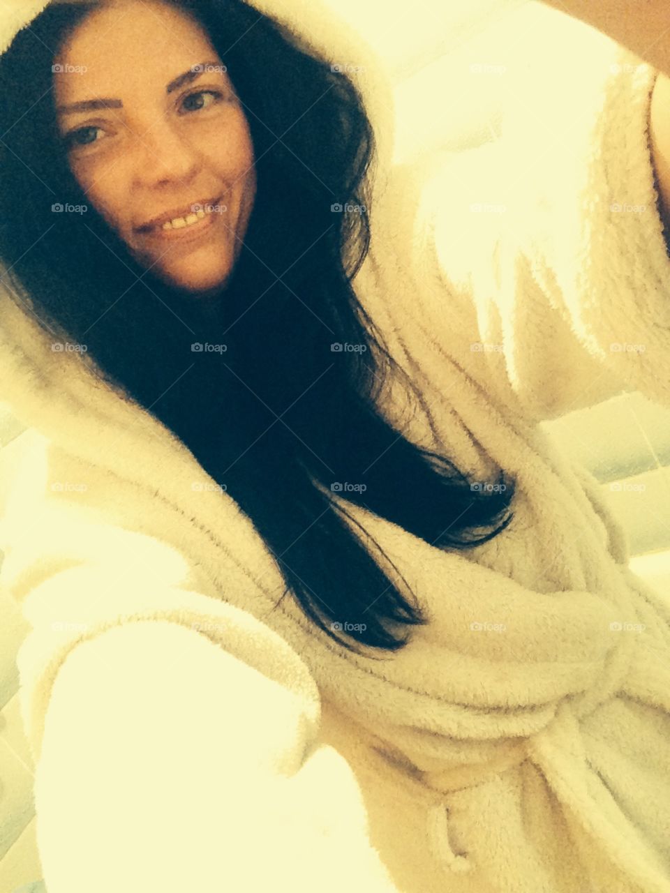 Smiling girl in the bath robe 