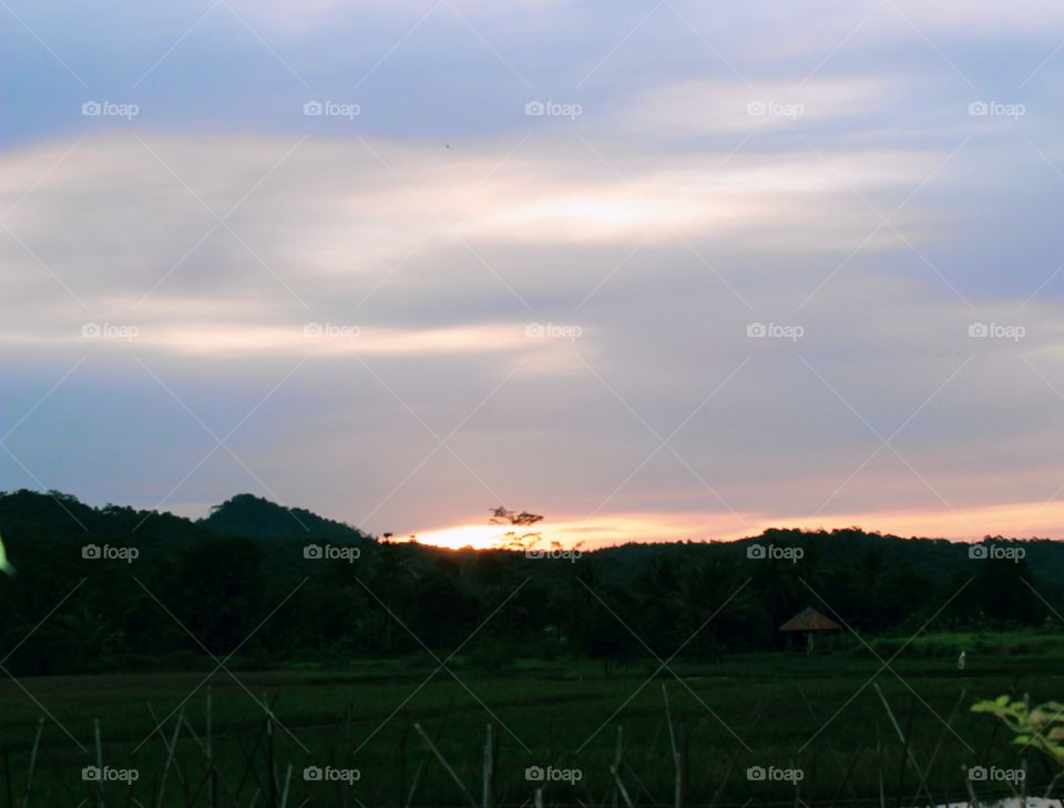 The sun's light on the western horizon looks red because the sun is about to set, meaning it's getting close to night and soon the moon will appear bringing its beautiful light.