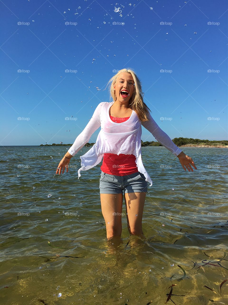 Woman splashing water at sea