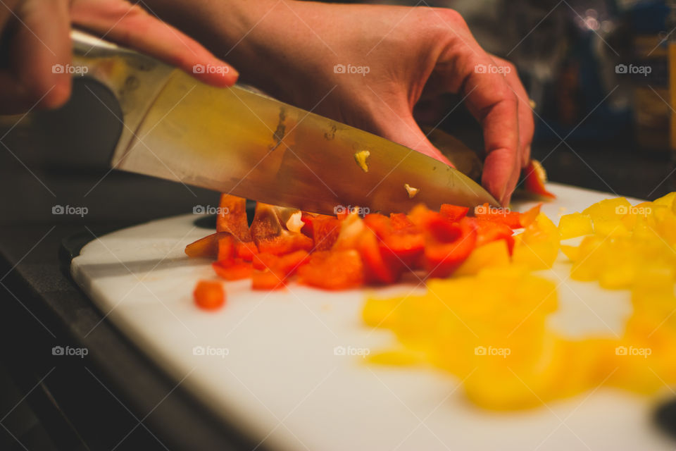 A person cutting pepper