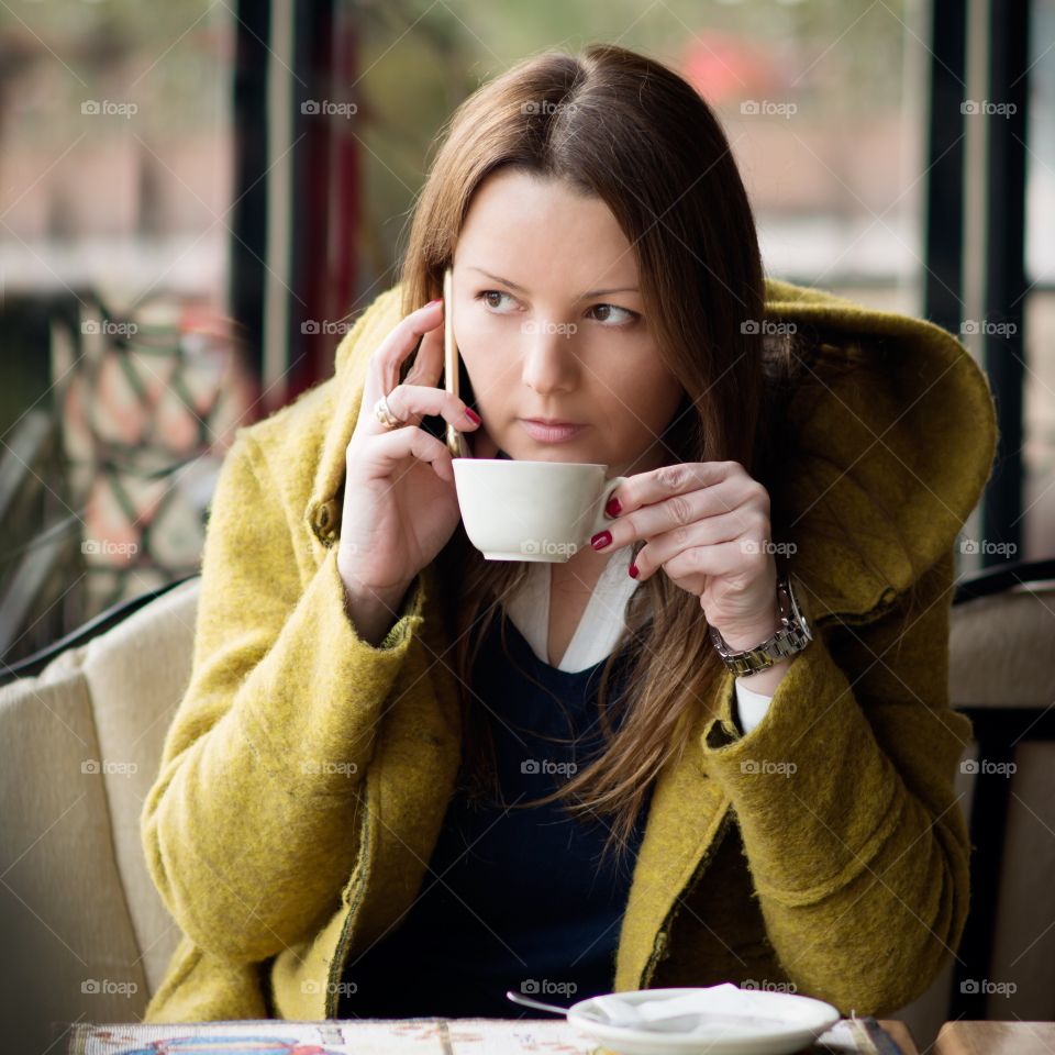 Young woman holding coffee mug in hand