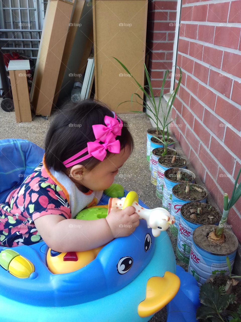 my cute little girl playing and watching my plants