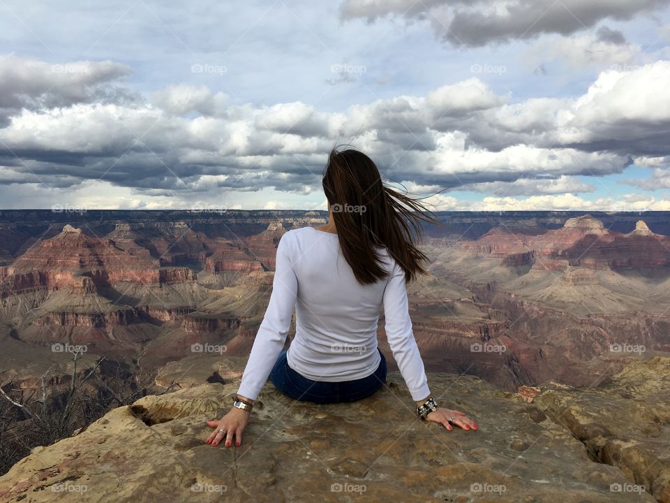 one woman seated relaxing and thinking looking at the Grand Canyon