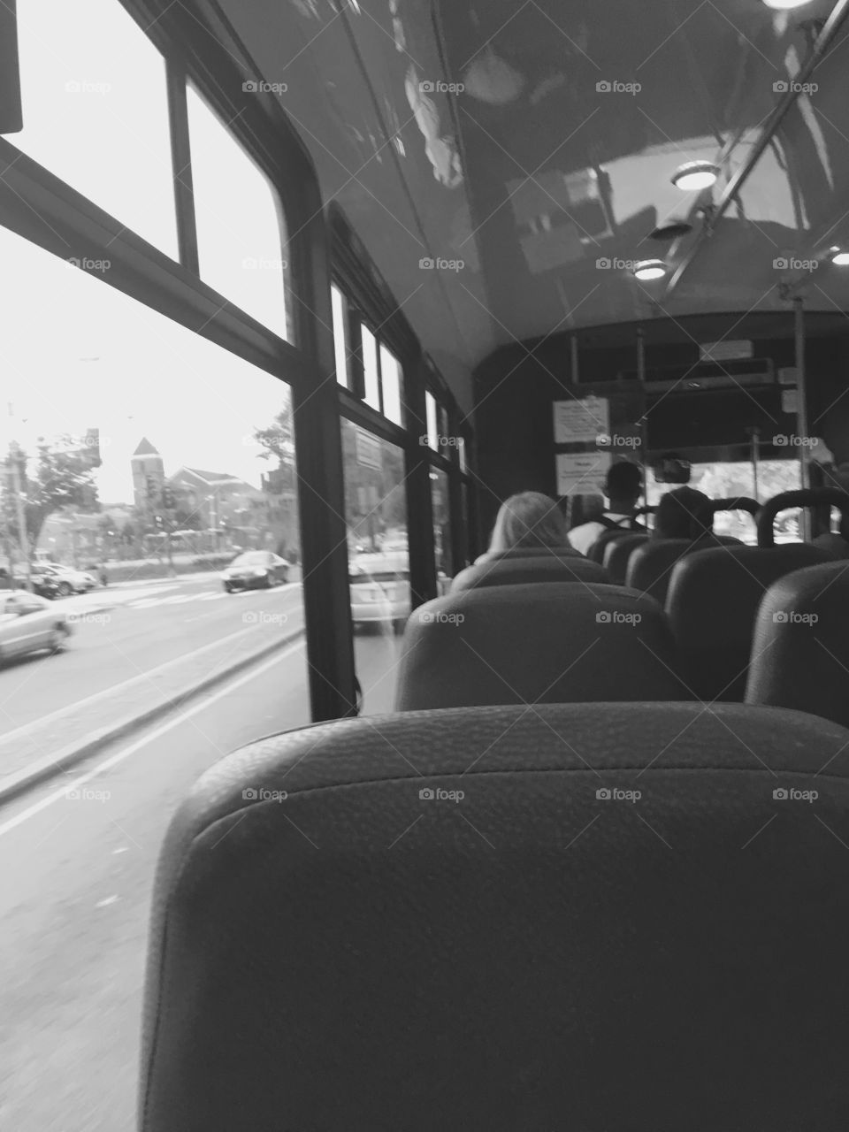 Sitting on the back of the bus as a black person in black and white