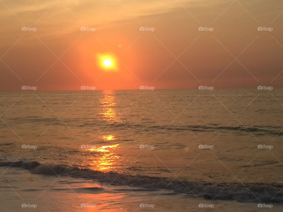 Sun sinking into ocean