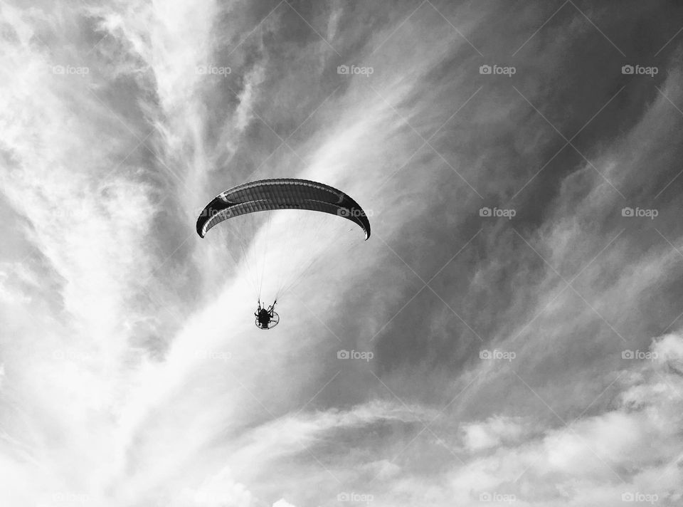 paraglider in the sky with clouds