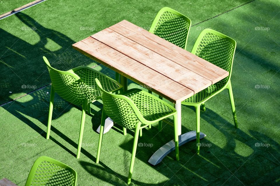 Green chair with wooden table