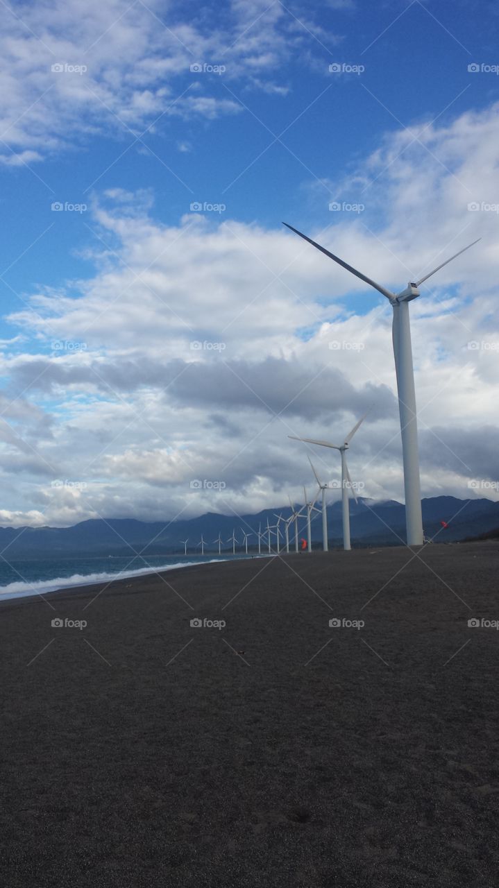 windmills beneath the clouds