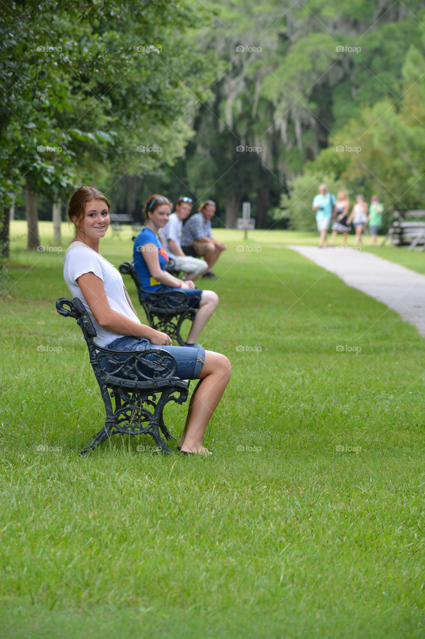 Smiling people sitting on bench