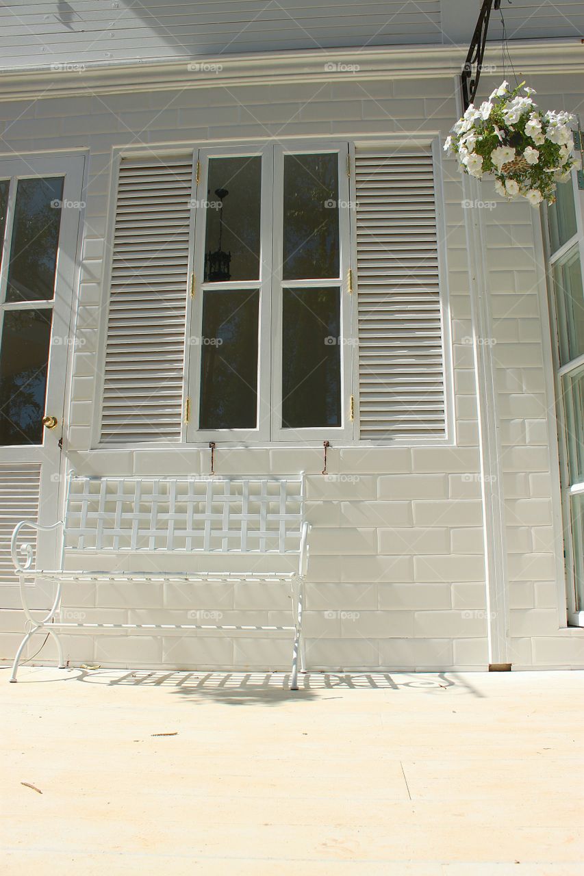 The beauty of a simple white window on brick walls, white couches and décor bring a white paste made simpler and more beautiful.