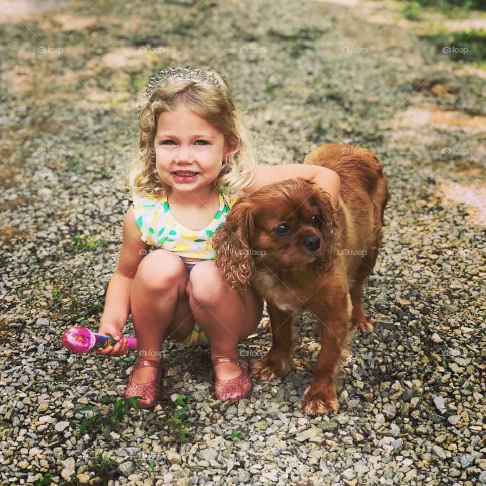 A little girl with her best canine friend. 