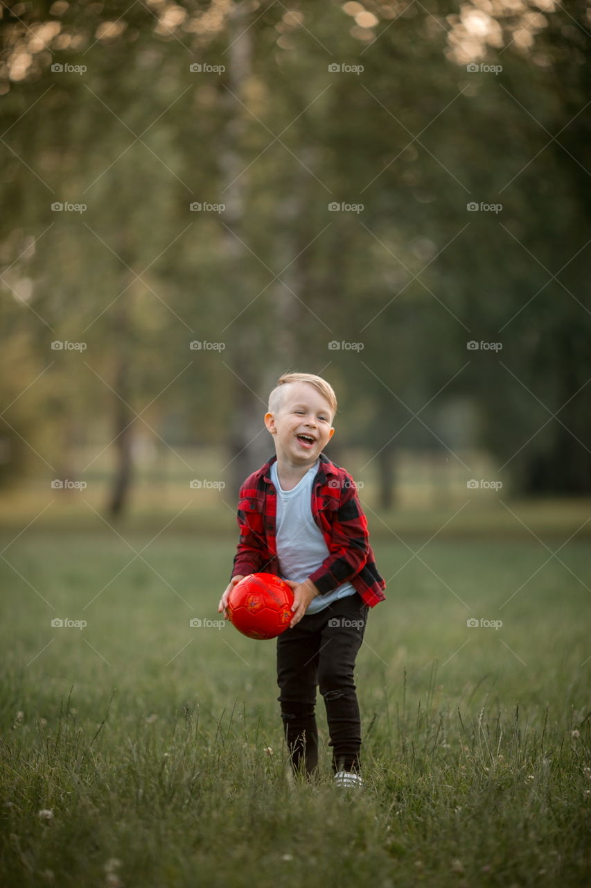 Little boy playing in soccer in a park 