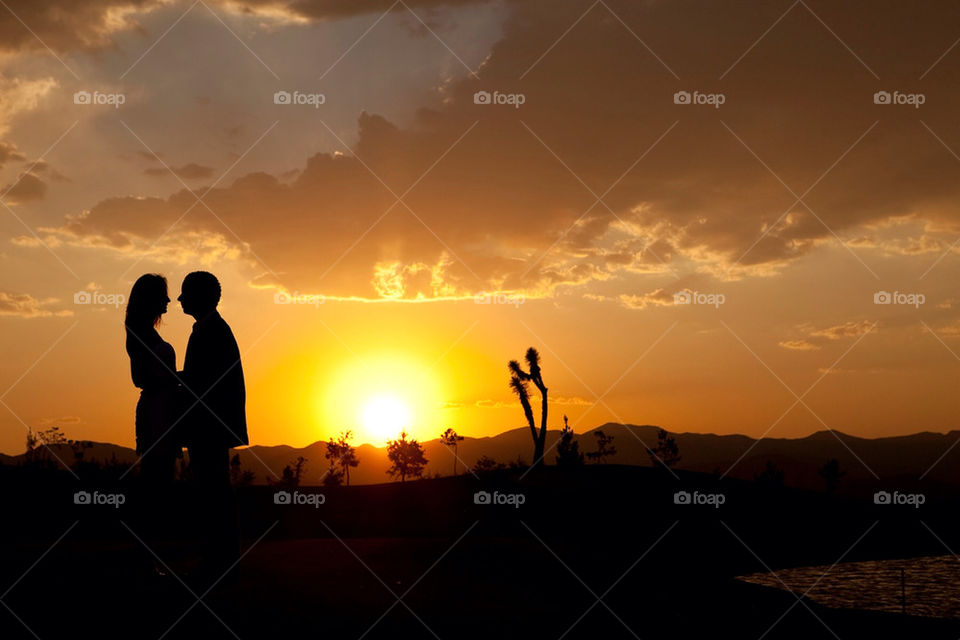 Couple of lovers in a desert sunset landscape
