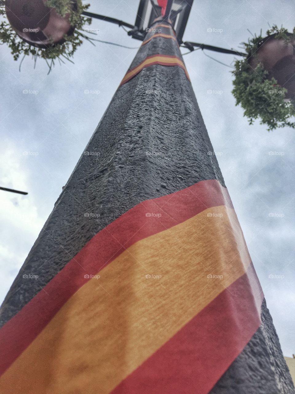 High above. An upshot of a street lamp decorated for a festival 