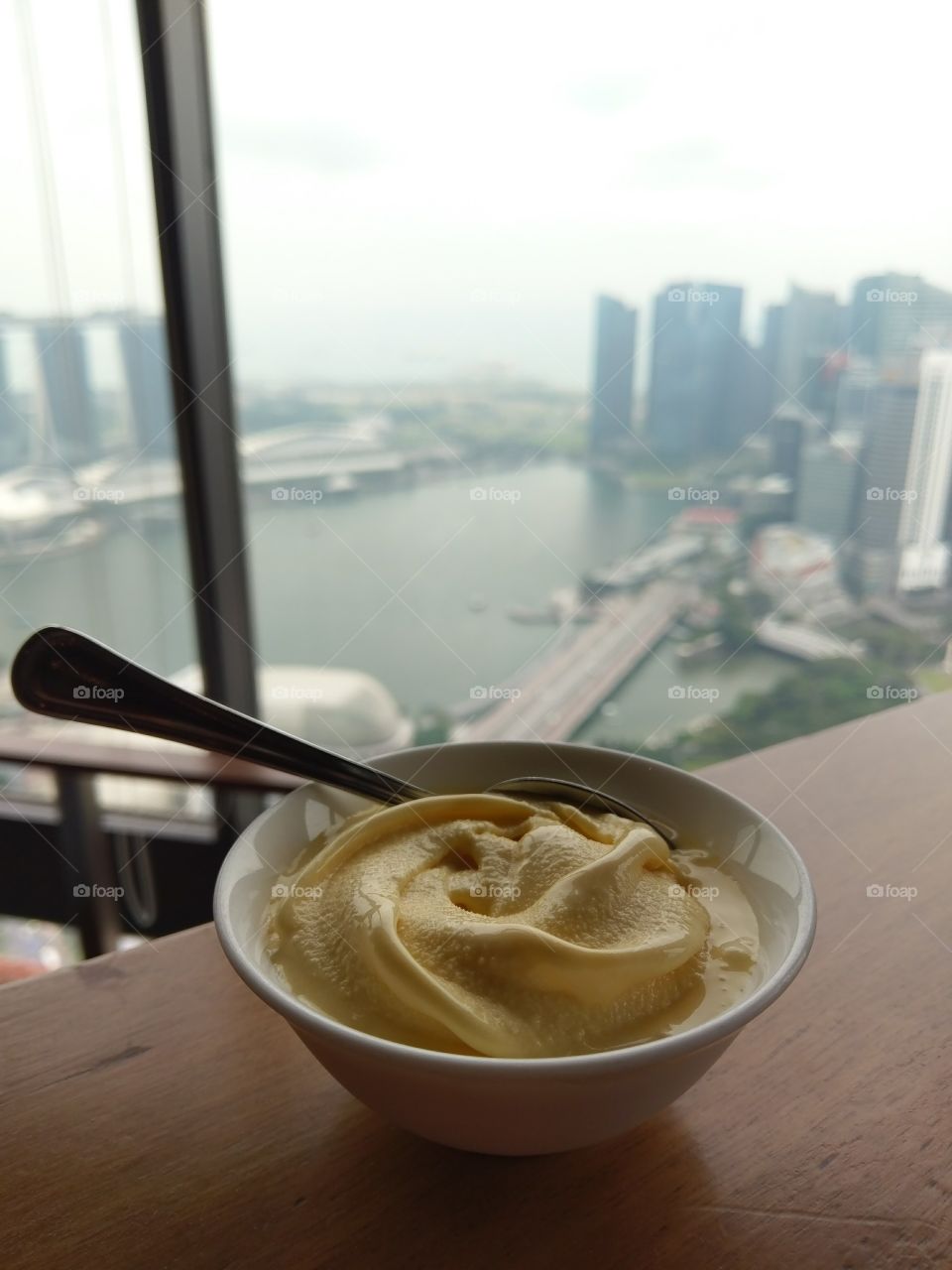 Green tea soft serve against the Marina Bay cityscape, Singapore. Photo taken from the Equinox.