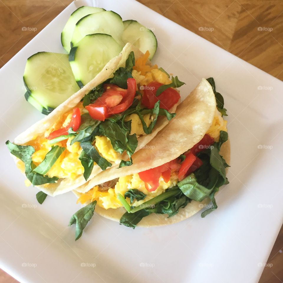 Who says you can’t have tacos for breakfast?! Not me!! The perfect breakfast taco filled with scrambled eggs, cream cheese, sharp cheddar, spinach and fresh tomatoes! The cucumbers tie in the freshness!