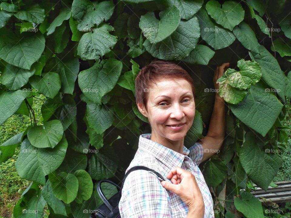 girl on the background of green leaves