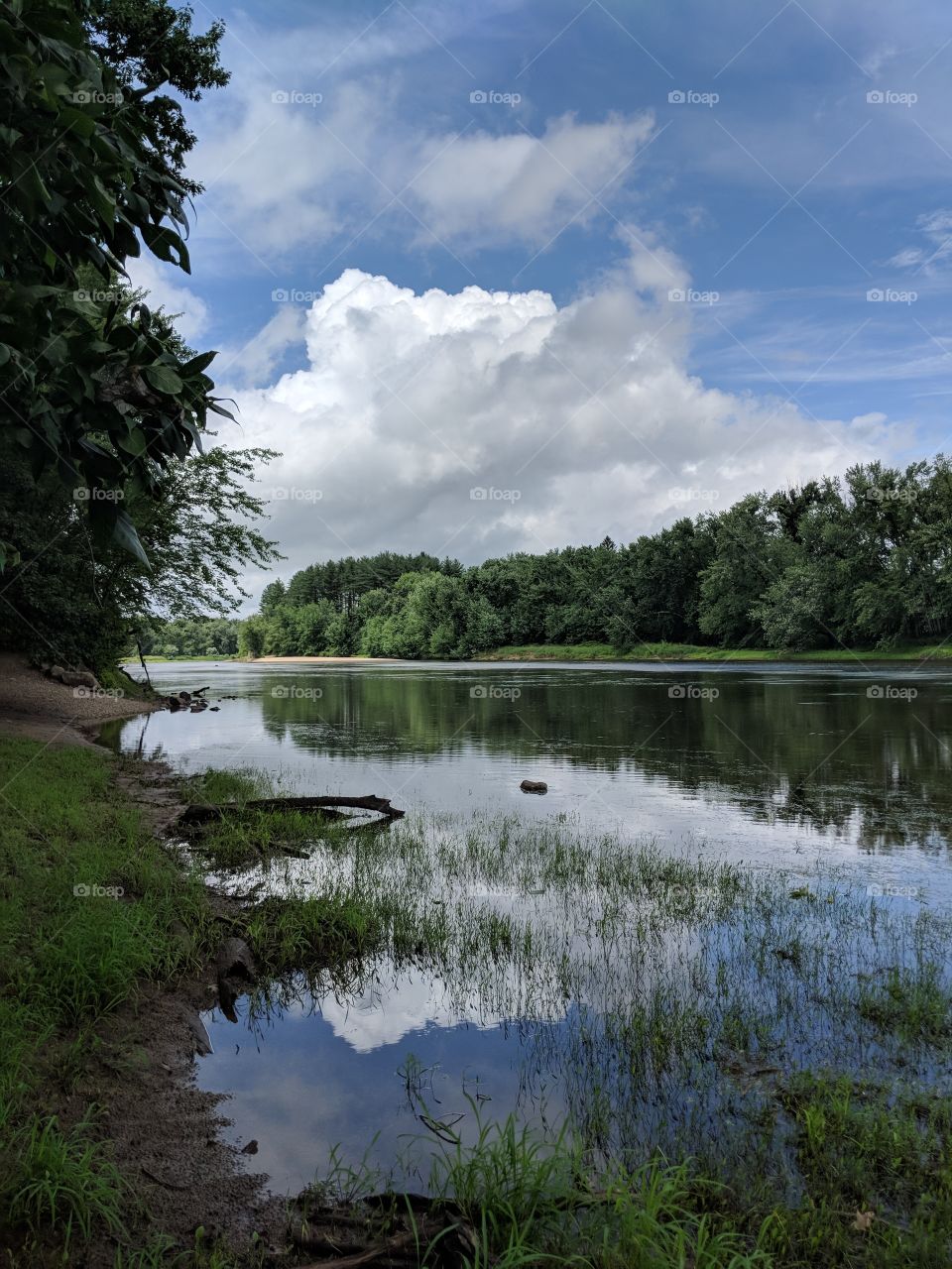 clouds reflected by river