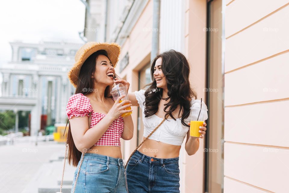 Young asian girls friends having fun in city street