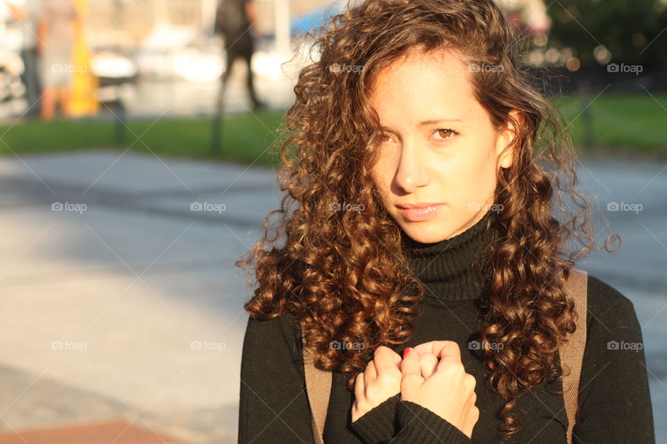 Portrait of young woman with curly hair