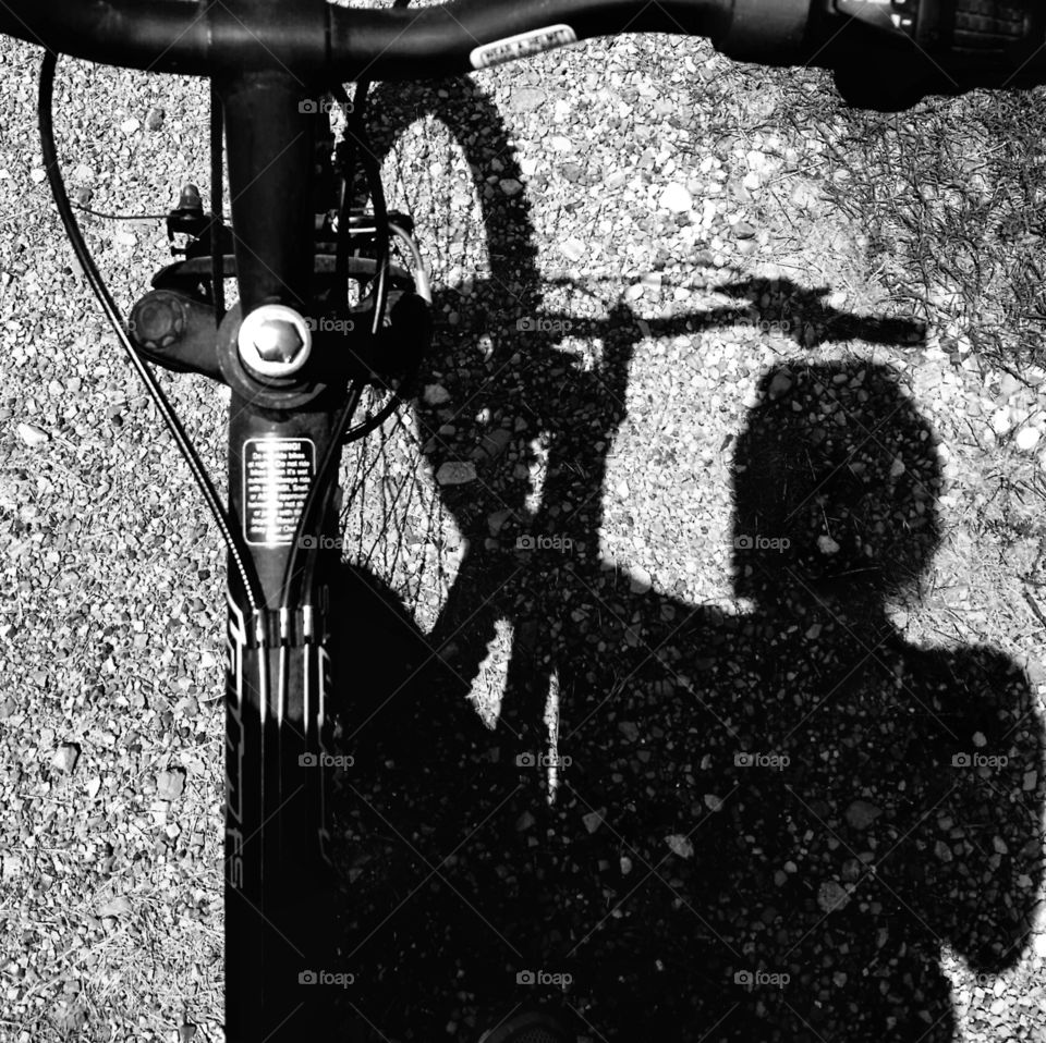 Shadow selfish of a woman riding a bicycle