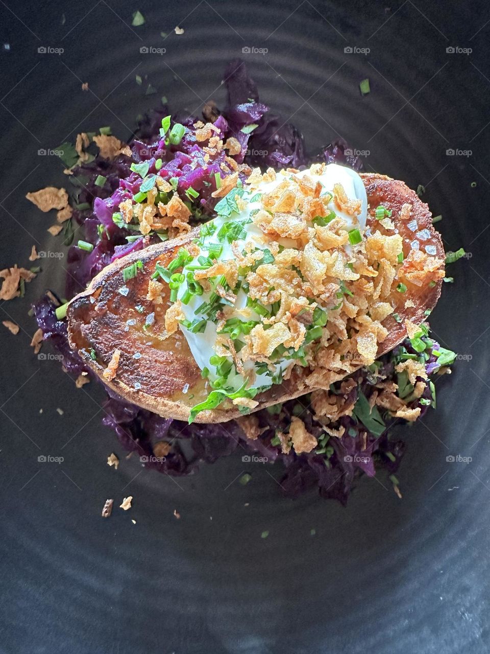 baked squash on top of cabbage in a black plate