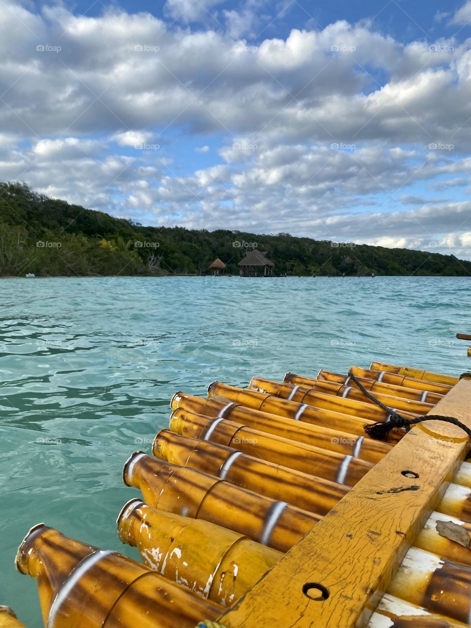Sitting on a bamboo raft in a lagoon with beautiful turquoise colored water