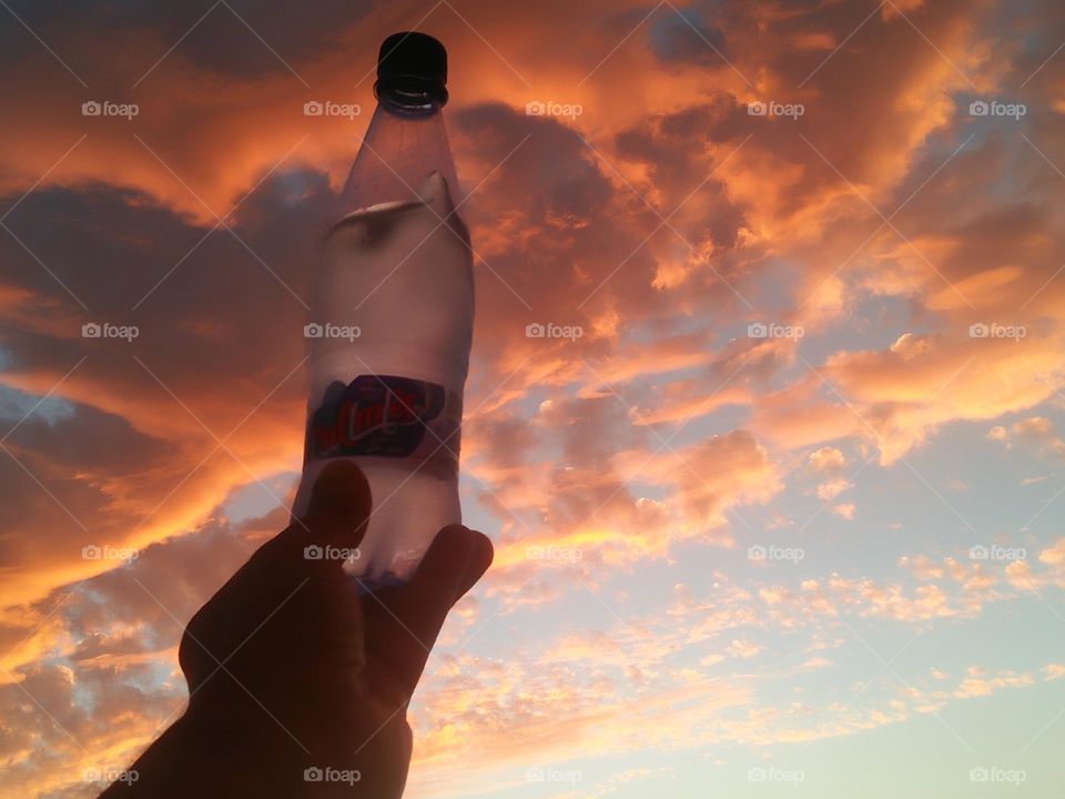 Magic sunset and a beautiful bottle embraces high sky.