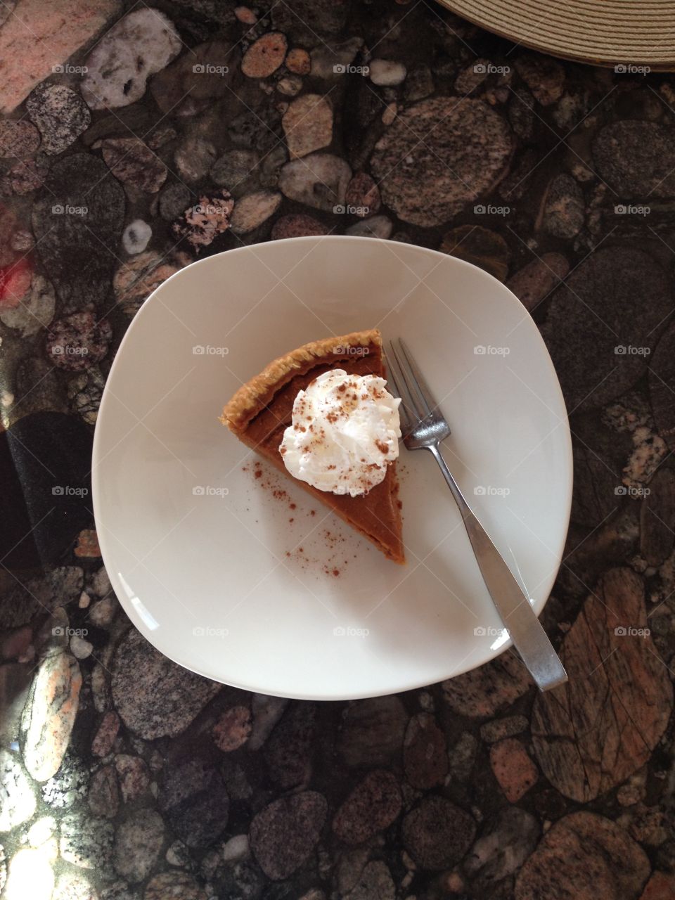 Homemade pumpkin pie, whipped cream from a can, cinnamon dusted over. Unfiltered/edited picture. 