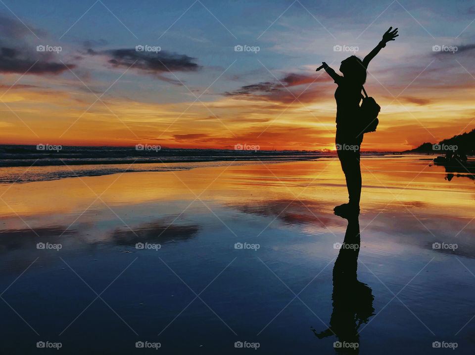 carefree woman dancing in the sunset on the beach. vacation vitality healthy living concept - Image