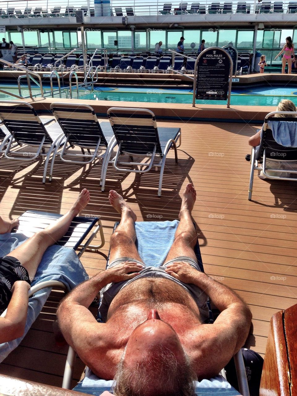 Man sun bathing on cruise ship deck