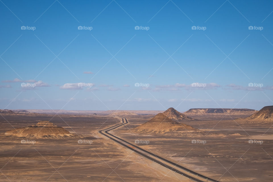 Beautiful long road to the horizon in the Black Desert, Egypt.