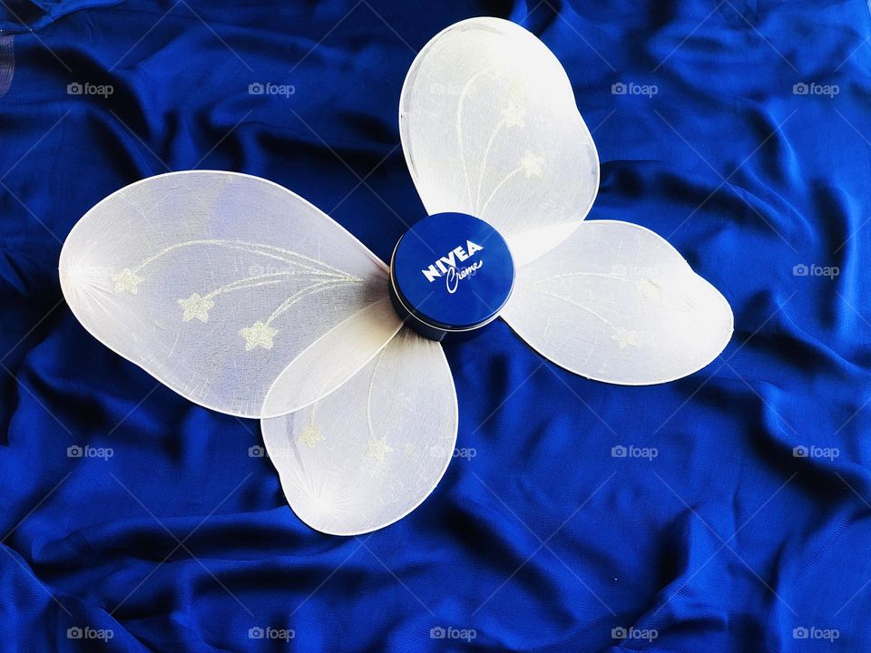 Nivea cream with white butterfly and blue background Nivea wings.