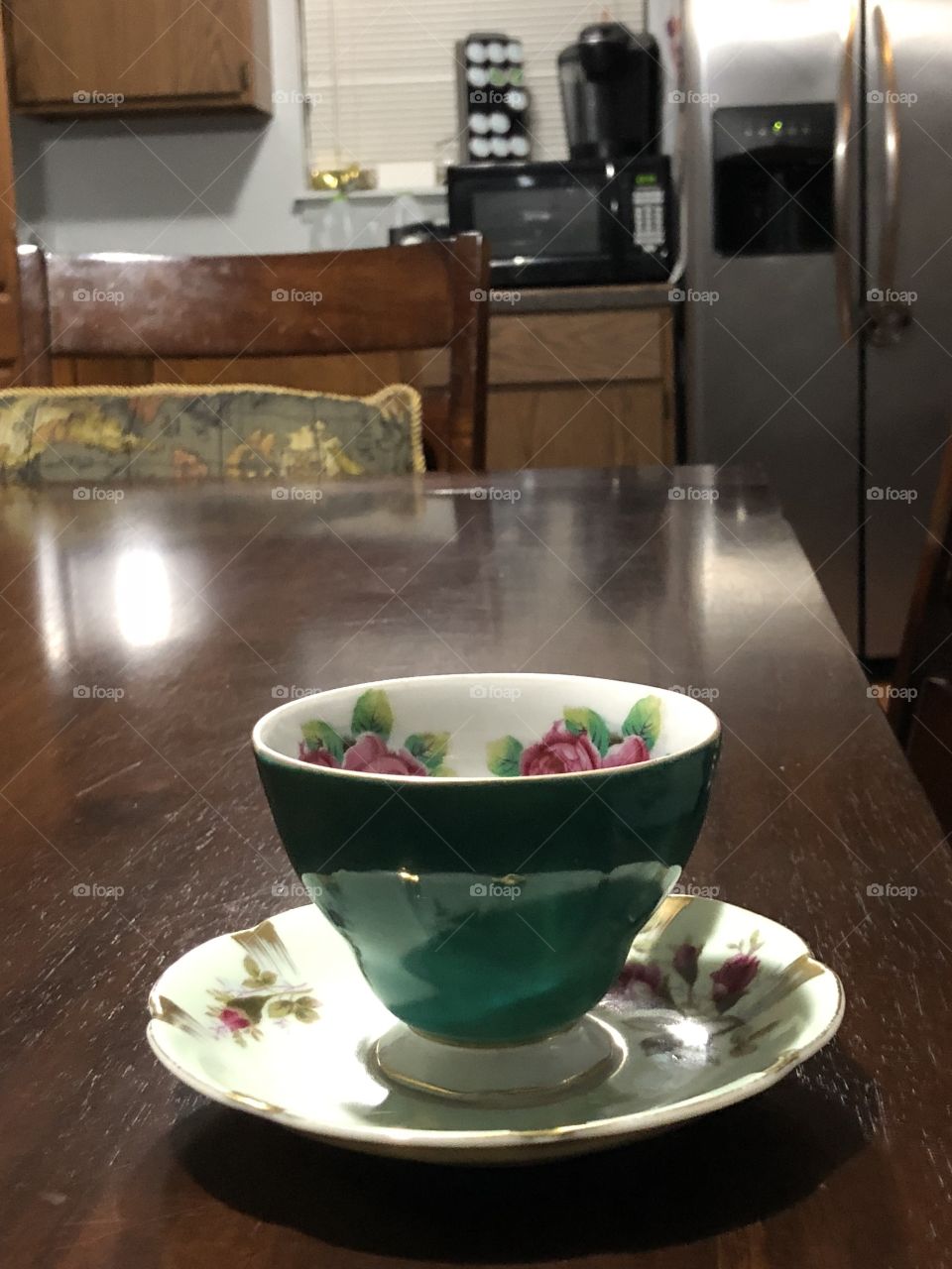 Tea cup and saucer. In dining and kitchen area of a home