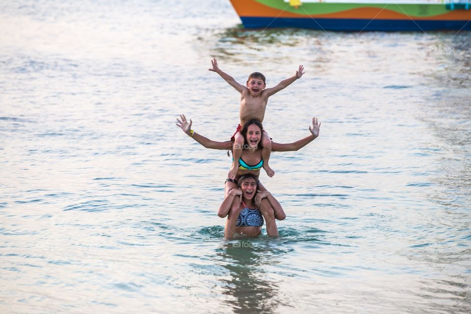 Girl carrying their sibling on shoulder