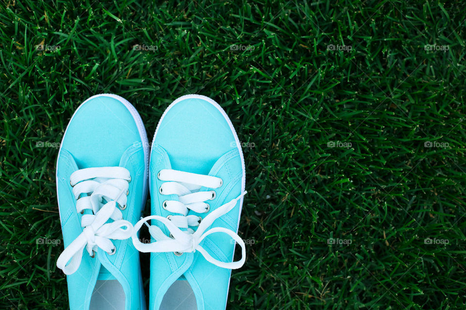 Shoes on grassy field