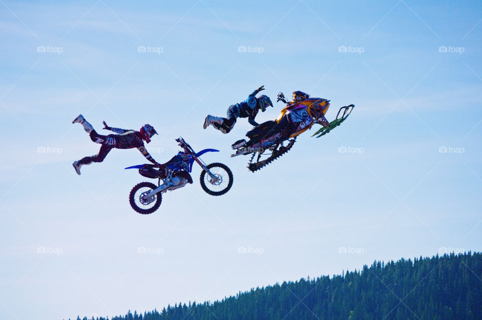 Jumping with motorcycle and snowmobile