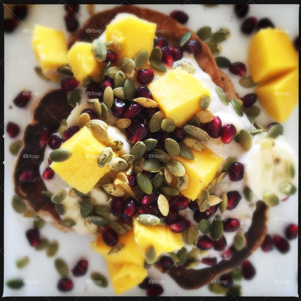 Green pancakes with fruits and nuts 