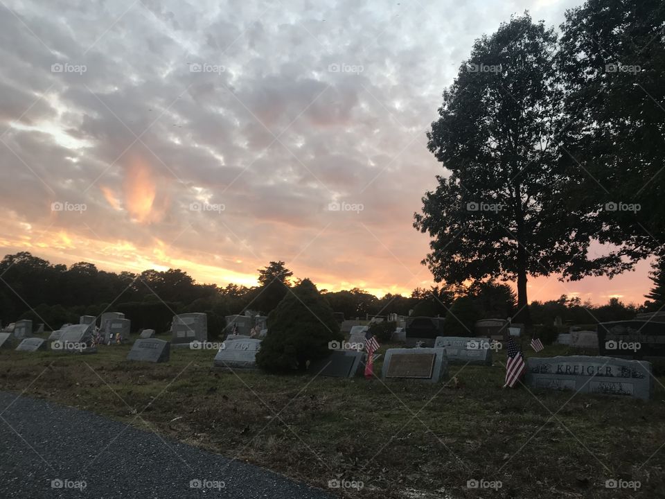 Sunset at the cemetery. Trees. Clouds. Honor. Loved 