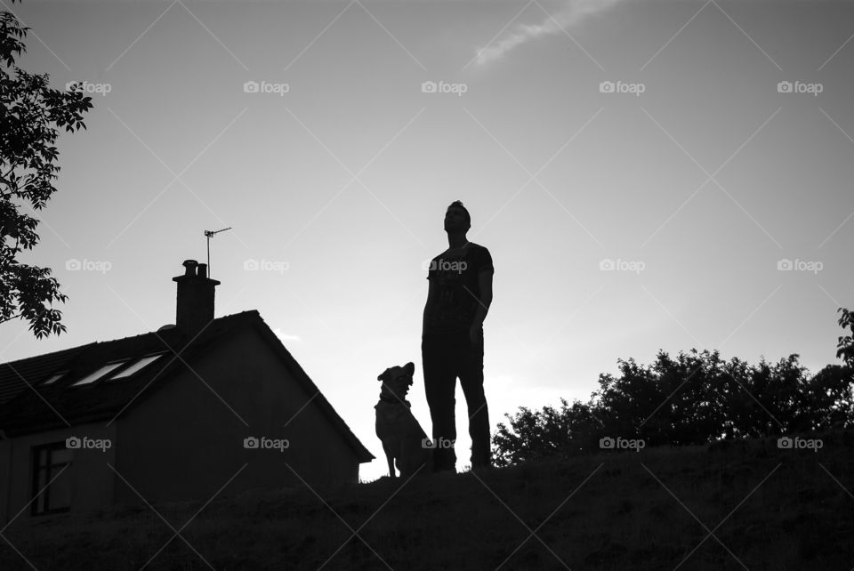 A man with dog. Looking in the sky