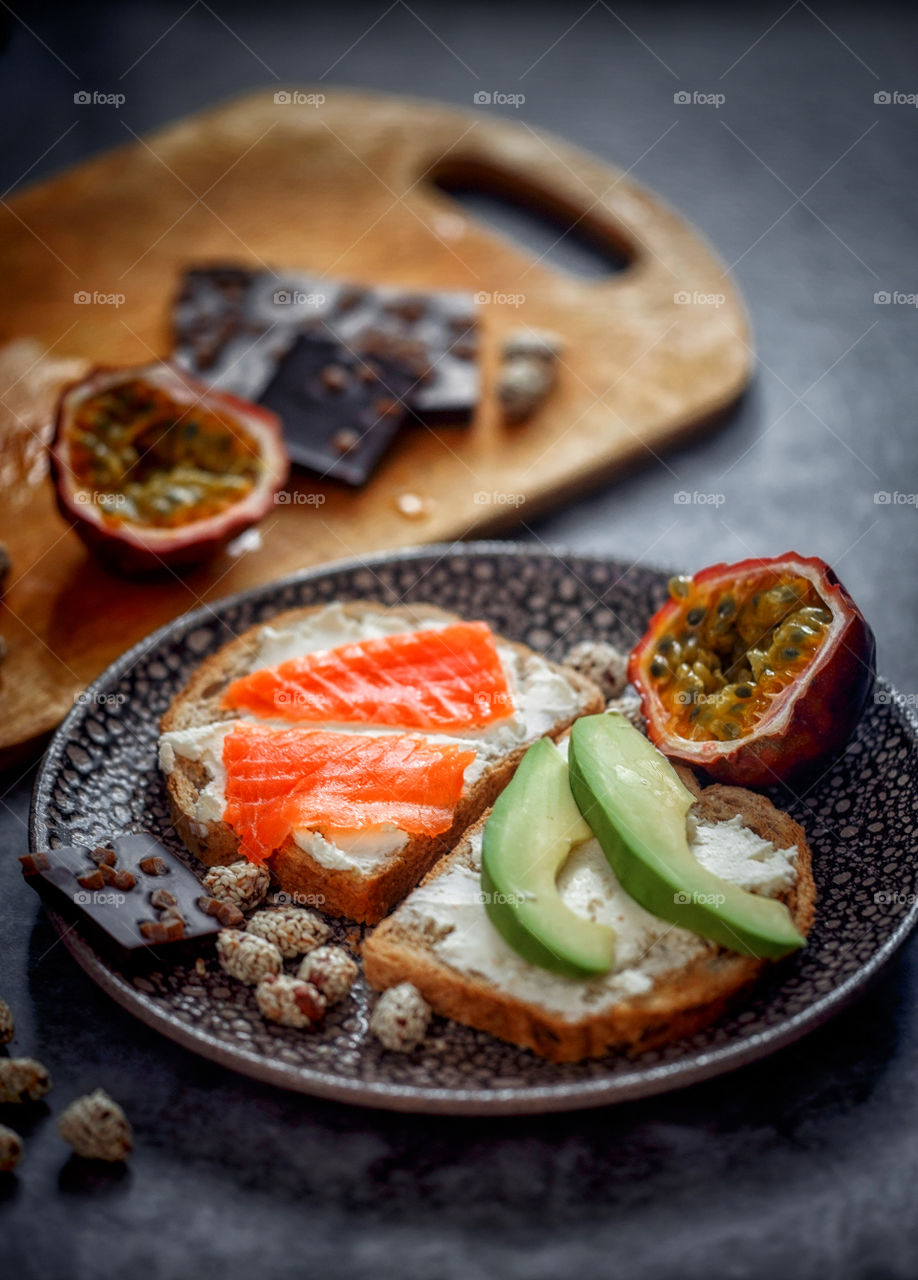 Dietary sandwiches of grain toasts with cream cheese, fish and avocado