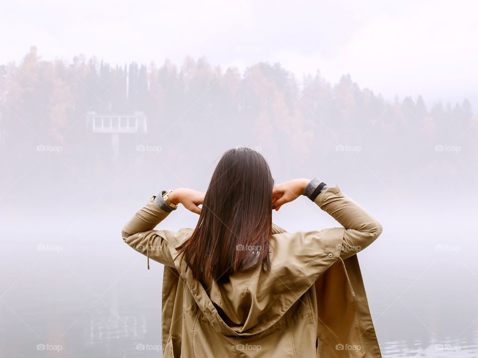 Rear view of a woman in foggy weather