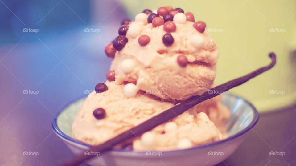 Vanilla bean on scoops of ice cream
