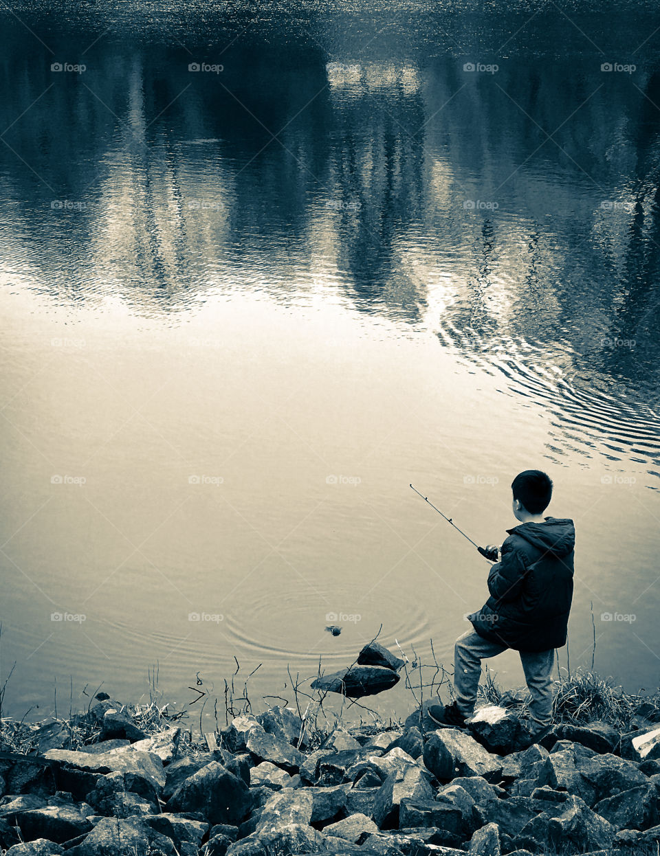 A boy fishing in the lake