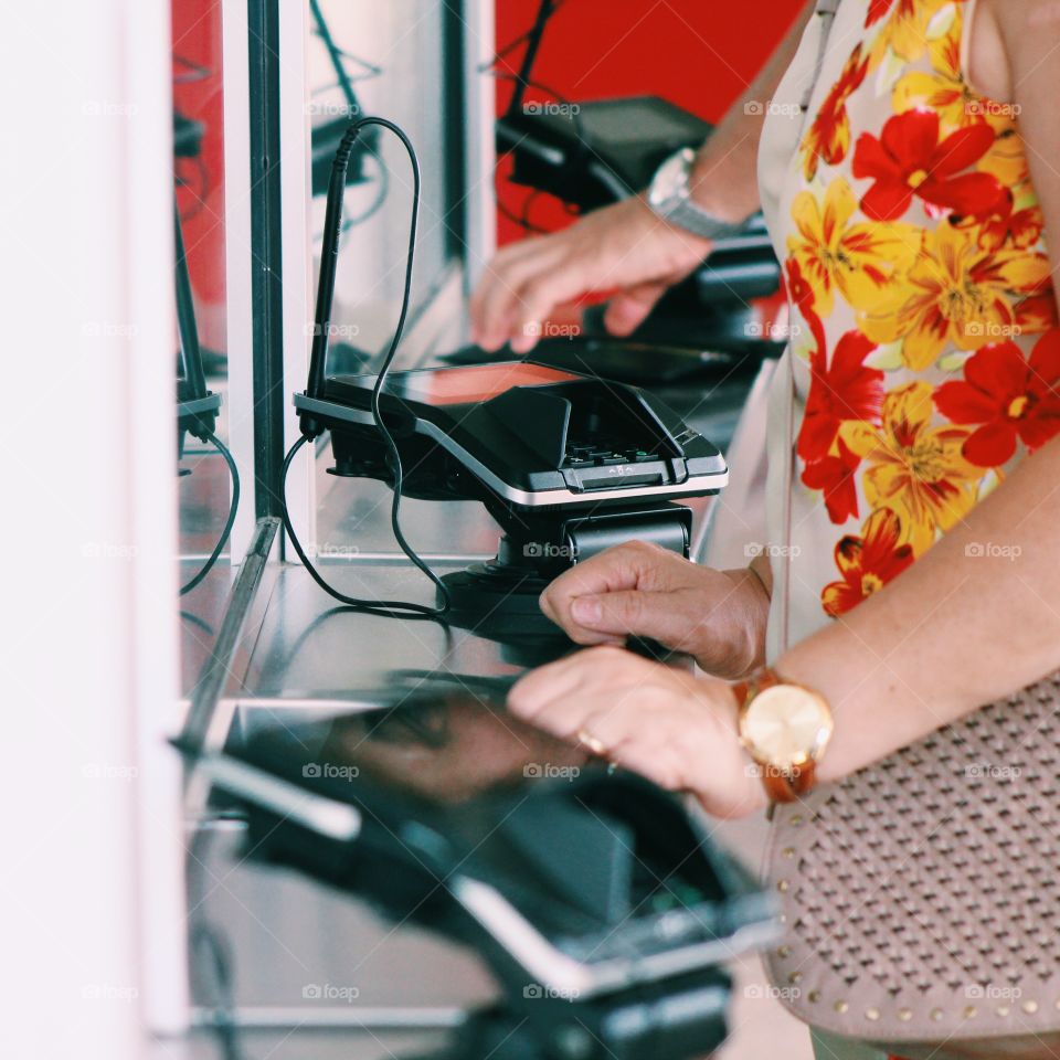 A woman swiping her credit card