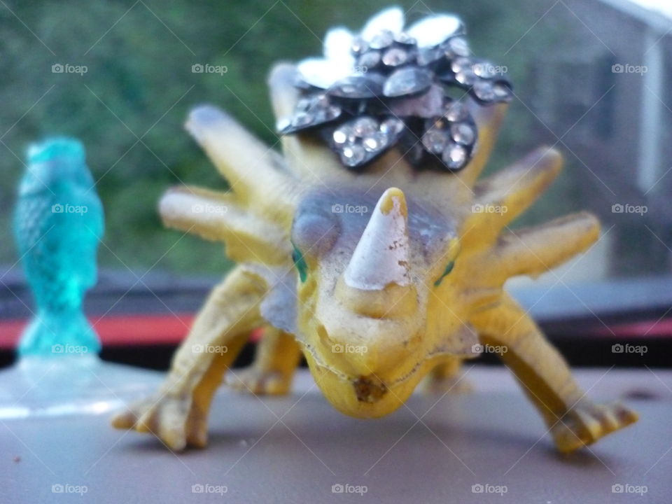 A small dragon toy with a jewelry decoration in a car