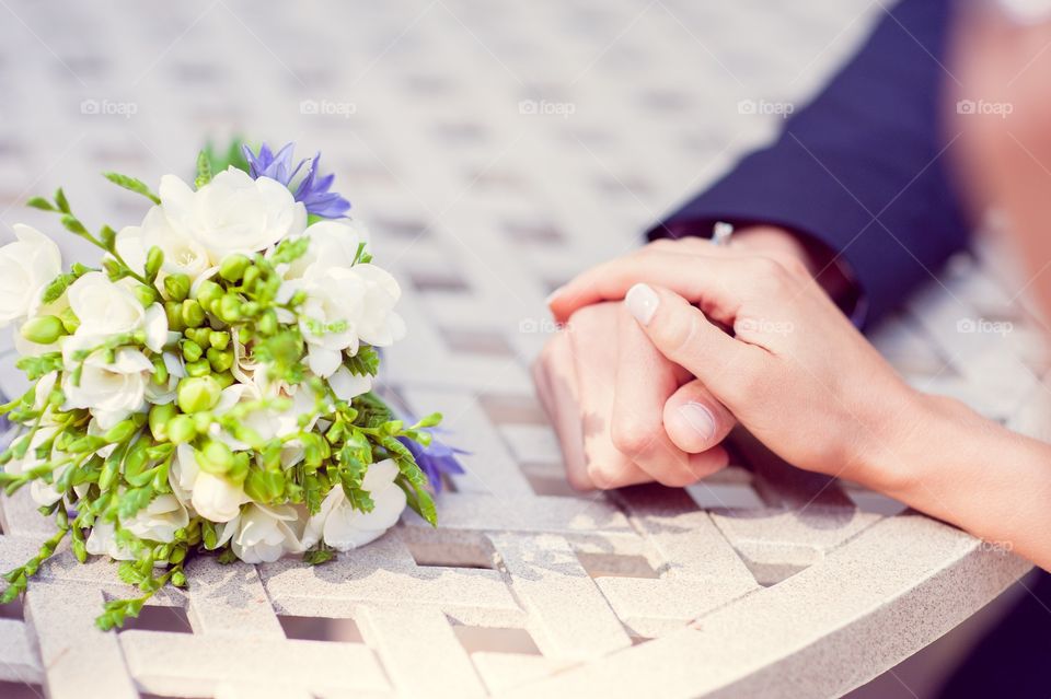 Bride and bridegroom holding hands