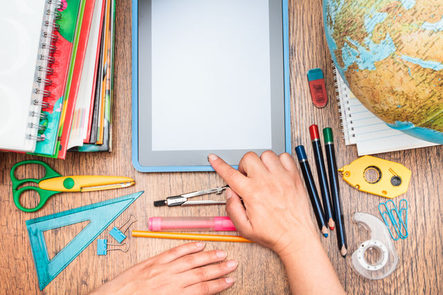 Elevated view of stationery with tablet