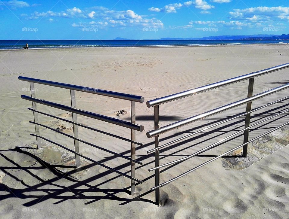 the fence in the sand of the beach